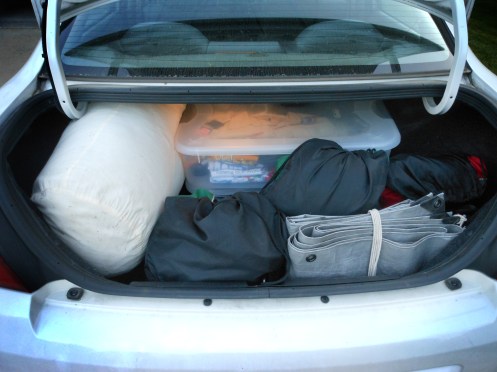 A car trunk fully loaded with camping gear