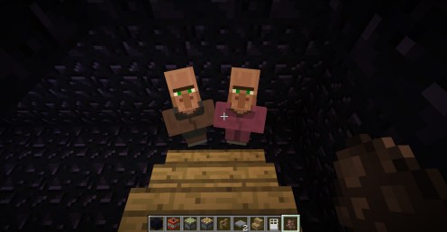 Two monsters look up from the bottom of the basement stairs