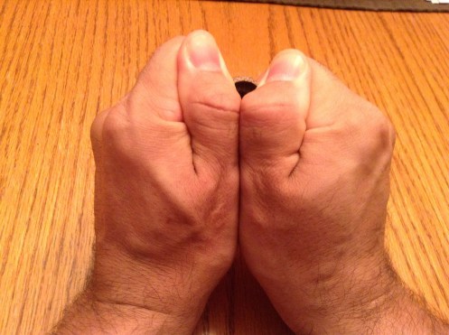 Modeling how to hold the acorn cap to make it into a whistle