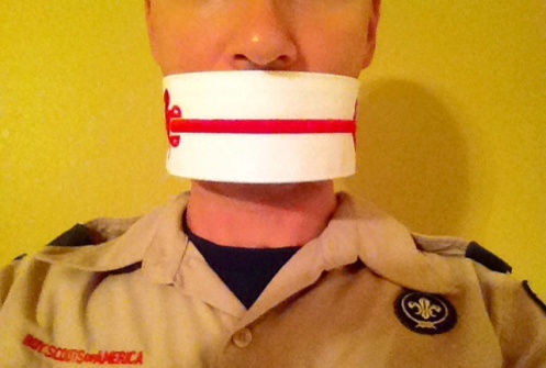 Man wih mouth gagged by order of the arrow sash